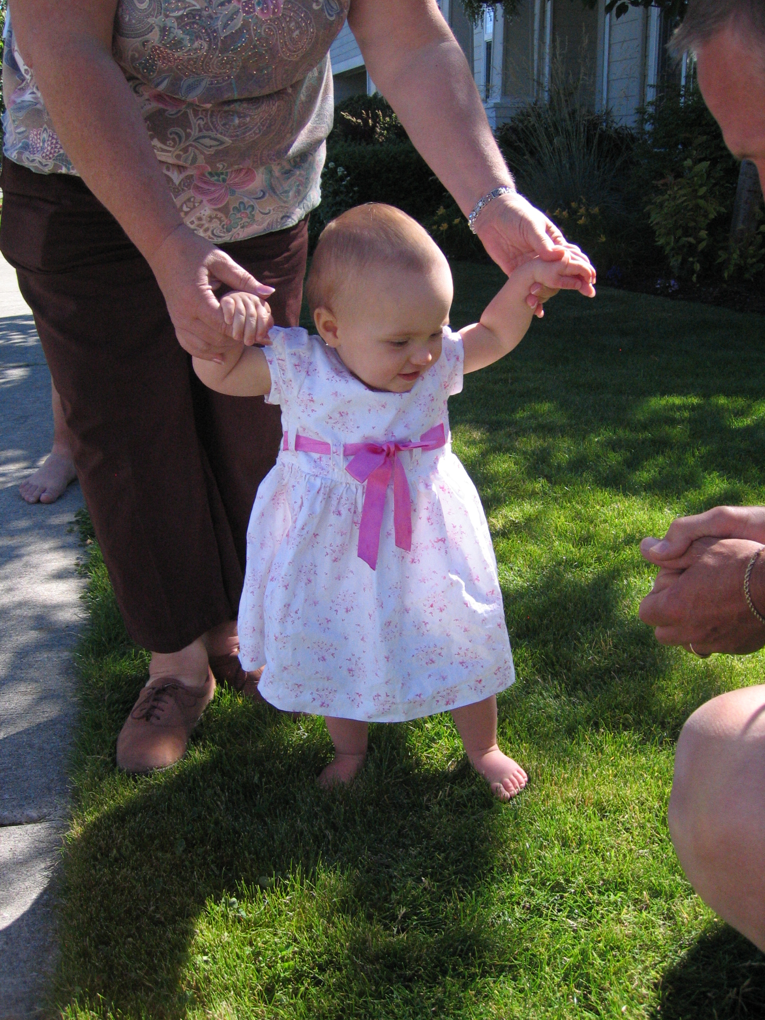 Megans1stbday/06_Megan_trying_out_the_grass.jpg