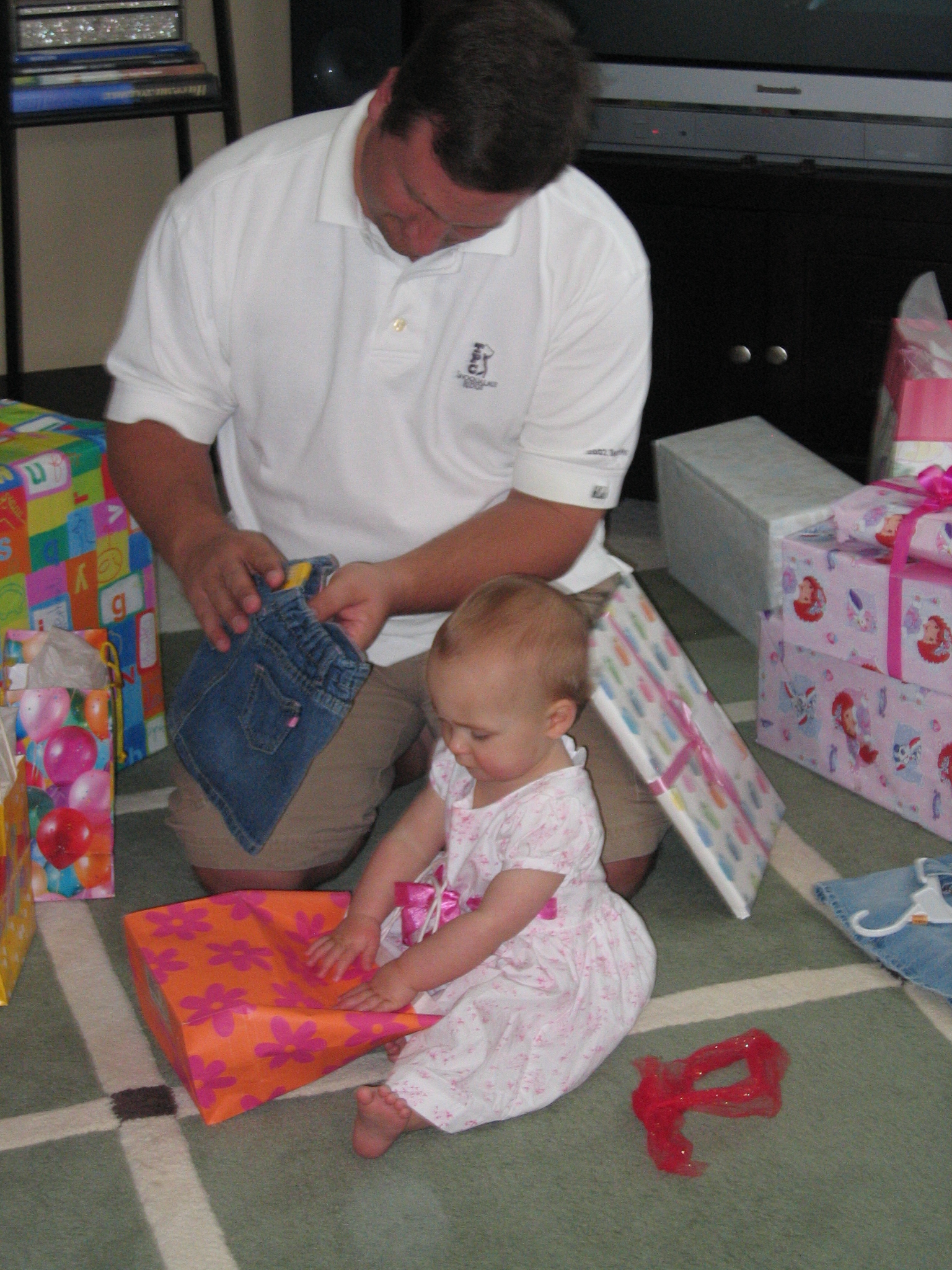 Megans1stbday/32_Matt_helping_Megan_open_presents.jpg